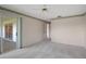 Spacious carpeted bedroom featuring a sliding glass door with access to the screened in lanai at 1654 Waxwing Ct, Venice, FL 34293