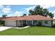 Charming single-story home featuring a beautiful tile roof, well-manicured lawn, and lush landscaping at 1654 Waxwing Ct, Venice, FL 34293