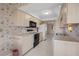 The kitchen features bright cabinetry, standard appliances, and tile flooring at 1654 Waxwing Ct, Venice, FL 34293