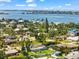 Aerial view of a home with a screened pool in a lush, green neighborhood near the water at 1723 Laramie St, Sarasota, FL 34231