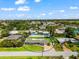 Aerial view of charming single-story home featuring a screened-in pool and lush green lawn at 1723 Laramie St, Sarasota, FL 34231