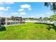 Large green yard is completely fenced with a screened pool area providing a private retreat at 1723 Laramie St, Sarasota, FL 34231