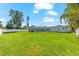 Sprawling backyard with well-maintained lawn and white fence plus a screened pool enclosure at 1723 Laramie St, Sarasota, FL 34231