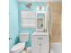 Bright bathroom with blue walls, tiled shower, and a white vanity with a marble countertop at 1723 Laramie St, Sarasota, FL 34231