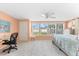 Comfortable bedroom with a work space and bed with a quilt with a beach motif at 1723 Laramie St, Sarasota, FL 34231