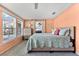 Bright bedroom with a bed with a quilt with a beach motif, dresser, and view to backyard at 1723 Laramie St, Sarasota, FL 34231