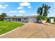 Charming single-story home with well-manicured lawn and long driveway at 1723 Laramie St, Sarasota, FL 34231