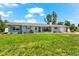 Beautiful single-story home with blue shutters and lush green lawn at 1723 Laramie St, Sarasota, FL 34231