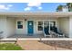 Inviting front porch with blue door and seating area at 1723 Laramie St, Sarasota, FL 34231