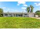 Charming single-story home boasts a well-manicured lawn, blue shutters and a one car garage at 1723 Laramie St, Sarasota, FL 34231