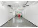 Tidy two-car garage with shiny epoxy floors and white walls is perfect for parking and storage at 1723 Laramie St, Sarasota, FL 34231