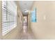 Bright hallway with tile floors, neutral walls, and access to bedrooms and bathrooms at 1723 Laramie St, Sarasota, FL 34231