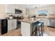Bright kitchen features an island with bar seating, granite countertops, and stainless steel appliances at 1723 Laramie St, Sarasota, FL 34231