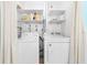 Bright laundry room with washer, dryer, shelving, and storage at 1723 Laramie St, Sarasota, FL 34231