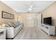 Cozy living room featuring a comfortable sofa, ceiling fan, and a view into the entry way at 1723 Laramie St, Sarasota, FL 34231