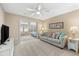 Bright living room with a comfortable sofa, ceiling fan, and a view into another room at 1723 Laramie St, Sarasota, FL 34231