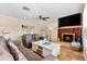 Cozy living room featuring a fireplace and plush seating with a view of the pool area at 1723 Laramie St, Sarasota, FL 34231