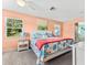 Bright main bedroom with a large bed and ensuite bathroom with a tub at 1723 Laramie St, Sarasota, FL 34231