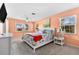 Spacious main bedroom with natural light, peach walls and coastal-themed décor at 1723 Laramie St, Sarasota, FL 34231
