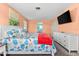 Peach main bedroom with tropical style bedding, a TV, and an ensuite bathroom at 1723 Laramie St, Sarasota, FL 34231