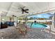 Relaxing covered patio with seating area overlooking a sparkling swimming pool at 1723 Laramie St, Sarasota, FL 34231