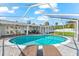 Bask in the sun on the lounge chairs by the kidney-shaped pool inside this screened enclosure at 1723 Laramie St, Sarasota, FL 34231