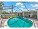 Relax in this beautiful kidney-shaped pool and patio with an attached covered seating area at 1723 Laramie St, Sarasota, FL 34231