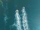 Aerial shot of two jet skis speeding across the water, creating white wakes at 1723 Laramie St, Sarasota, FL 34231