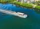 Tour boat cruising on the water; green foliage lines the shore behind buildings on a sunny day at 1723 Laramie St, Sarasota, FL 34231