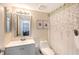 Clean bathroom with a modern vanity, framed art, and a shower with leaf-patterned curtain at 2124 N Tamiami Trl # 108, Sarasota, FL 34234