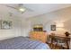 Bright bedroom featuring a ceiling fan, natural wood dresser, and a cozy desk area at 2124 N Tamiami Trl # 108, Sarasota, FL 34234
