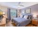 Inviting bedroom features a plush bed, complementary colored walls and artwork, and ample natural light at 2124 N Tamiami Trl # 108, Sarasota, FL 34234