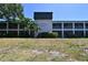 A daytime view of Whitaker Bayou condos with landscaping and a manicured lawn in front of the building at 2124 N Tamiami Trl # 108, Sarasota, FL 34234