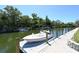 View of private boat dock and serene canal on a sunny day with lush greenery surrounding the waterway at 2124 N Tamiami Trl # 108, Sarasota, FL 34234