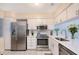 Modern kitchen featuring stainless steel appliances, white cabinets, and quartz countertops, perfect for culinary enthusiasts at 2124 N Tamiami Trl # 108, Sarasota, FL 34234