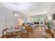 Bright living room with modern furnishings, dining area, and sliding glass doors to the balcony at 2124 N Tamiami Trl # 108, Sarasota, FL 34234