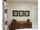 Wooden dresser with artfully displayed frames and a modern decorative piece at 2124 N Tamiami Trl # 108, Sarasota, FL 34234