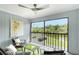 Inviting enclosed patio with comfortable seating and a scenic canal view, great for relaxing outdoors at 2124 N Tamiami Trl # 108, Sarasota, FL 34234
