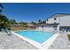 Community pool with clear blue water, lounge chairs, and a convenient pool house at 2124 N Tamiami Trl # 108, Sarasota, FL 34234