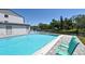 Enjoy the pristine community pool with tiled trim and relaxing green lounge chairs at 2124 N Tamiami Trl # 108, Sarasota, FL 34234