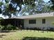 Tranquil backyard featuring a screened-in lanai, mature landscaping, and a well-maintained lawn at 2475 Wood Oak Dr, Sarasota, FL 34232