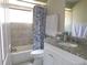 Bathroom with shower/tub, neutral tile, and granite vanity top at 2475 Wood Oak Dr, Sarasota, FL 34232