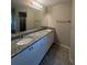 Bathroom featuring a dual sink vanity with granite countertop and cabinets, providing ample space and storage at 2475 Wood Oak Dr, Sarasota, FL 34232