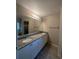 Bathroom features double vanity with granite countertop, white cabinets, and a shower at 2475 Wood Oak Dr, Sarasota, FL 34232