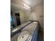 Bathroom features double vanity with granite countertop, white cabinets, and a shower at 2475 Wood Oak Dr, Sarasota, FL 34232