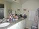 Bathroom featuring granite countertops, double sinks, and white cabinets at 2475 Wood Oak Dr, Sarasota, FL 34232