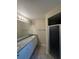 Bathroom featuring a dual sink vanity with granite countertop and cabinets, plus a walk-in shower at 2475 Wood Oak Dr, Sarasota, FL 34232