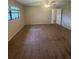 Cozy bedroom with neutral walls, plush carpeting, and a ceiling fan, offering a comfortable and relaxing space at 2475 Wood Oak Dr, Sarasota, FL 34232
