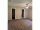 Spacious bedroom with neutral paint, ceiling fan, and carpet flooring, creating a cozy and inviting atmosphere at 2475 Wood Oak Dr, Sarasota, FL 34232