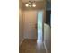 Entryway with neutral-colored tile flooring, white front door, and textured glass sidelight at 2475 Wood Oak Dr, Sarasota, FL 34232